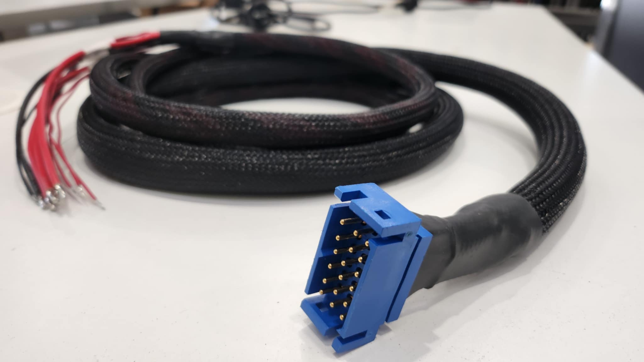 Blue automotive control connector cable produced by Control Cables Australia, designed for precision wiring in the automotive industry.